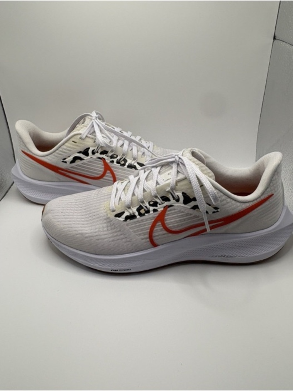 Nike Women’s White Running Sneakers with Orange Swoosh and Black Accent